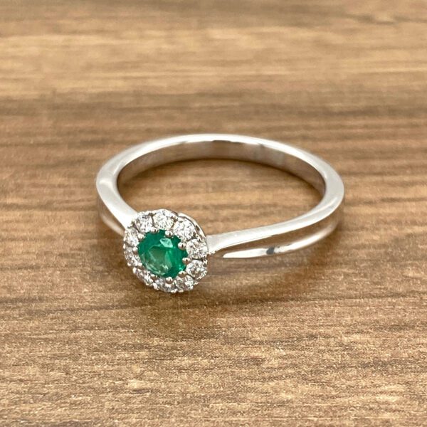 Emerald and diamond halo ring.