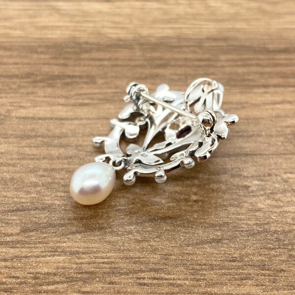 Silver pearl and garnet brooch back.