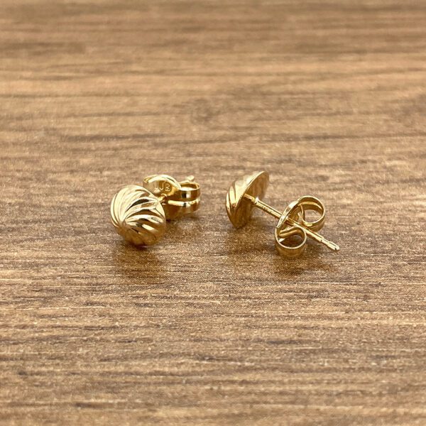 Pair of gold textured stud earrings.