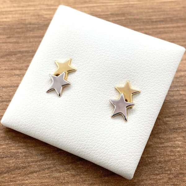 Gold and silver star stud earrings.