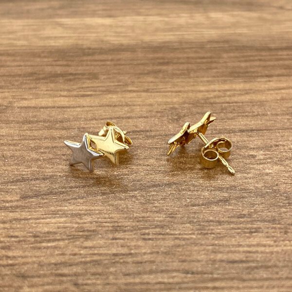 Gold and silver star stud earrings.