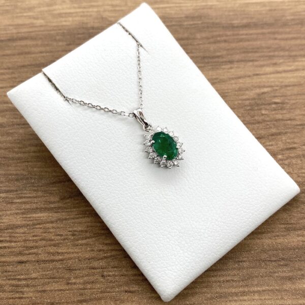 Emerald and diamond pendant necklace.