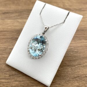 Aquamarine pendant with diamond halo.