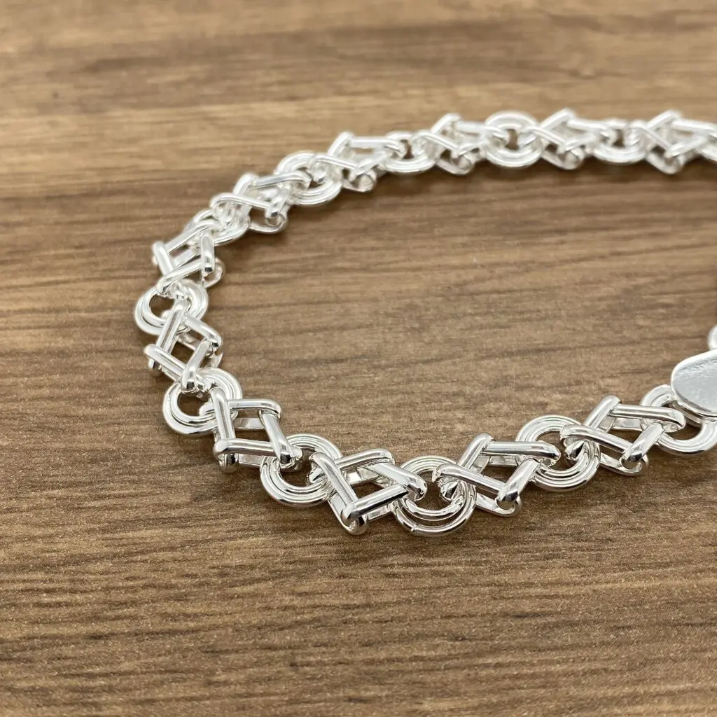 Silver link bracelet, intricate design.