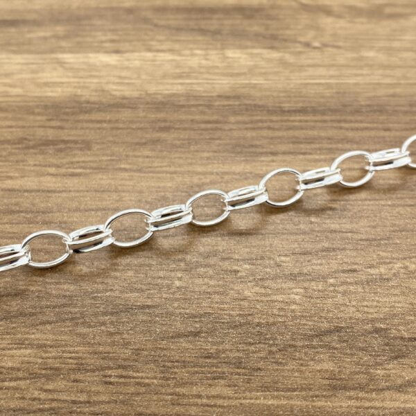 Silver chain link bracelet on wood.