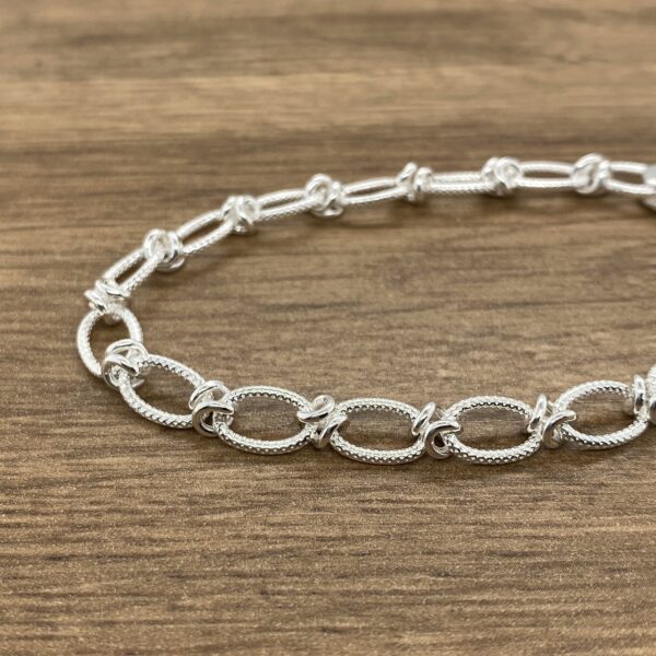 Silver textured oval link bracelet.