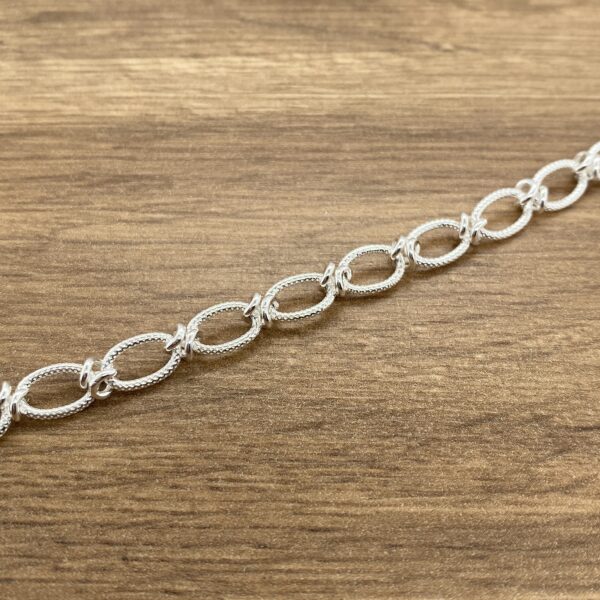 Silver textured oval link bracelet.