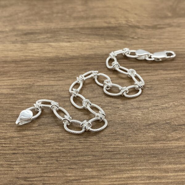 Silver textured oval link bracelet.