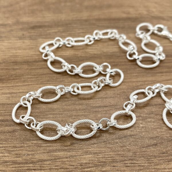 Silver oval link chain necklaces.