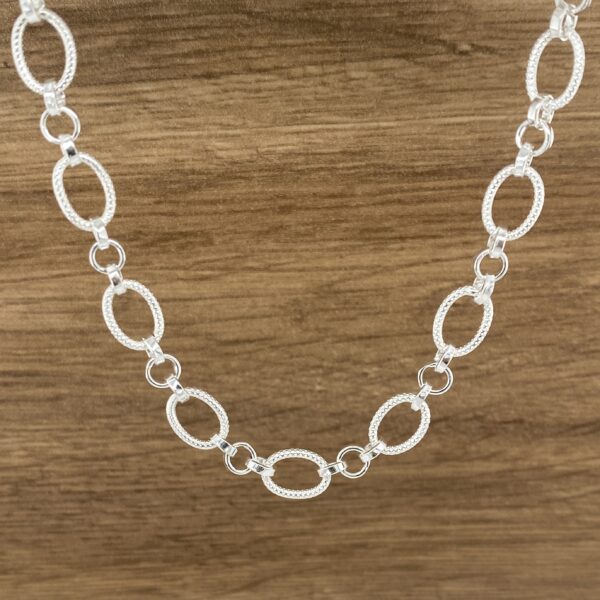 Silver oval link chain necklace.