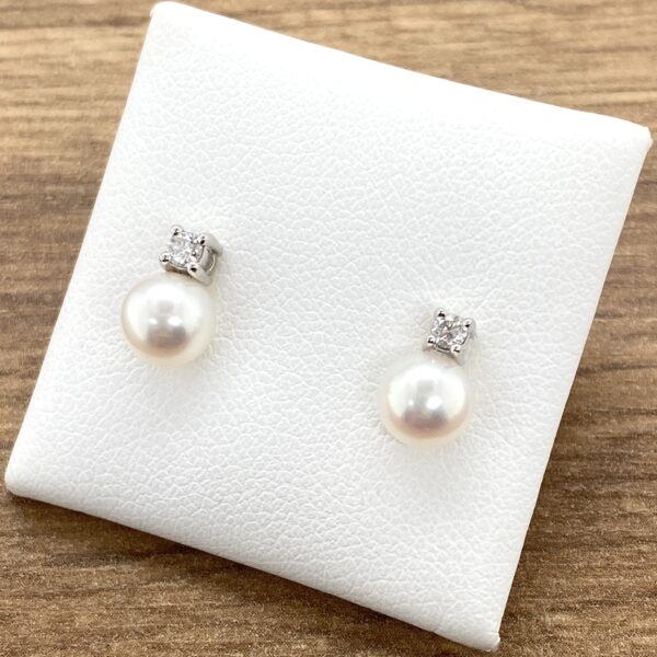 Pearl and diamond stud earrings.