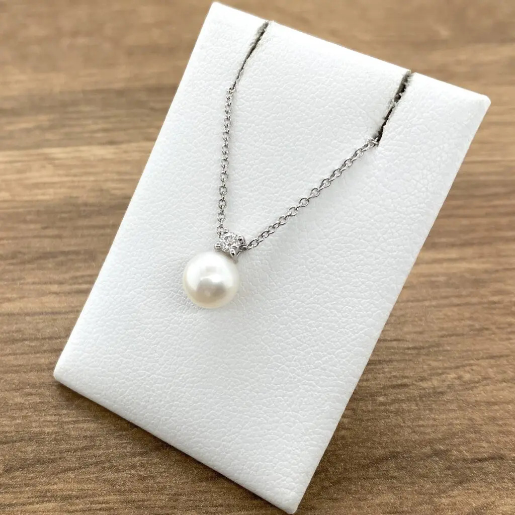 Elegant pearl and diamond pendant necklace.