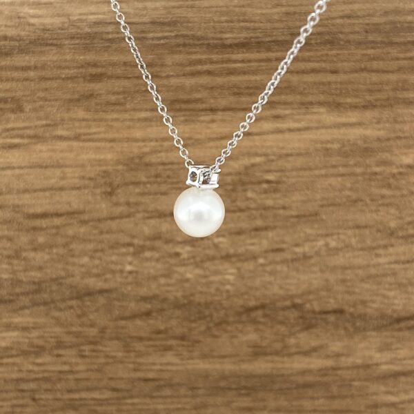 Elegant pearl and diamond pendant necklace.