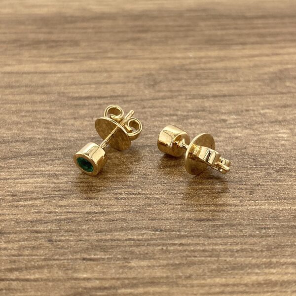 Gold emerald stud earrings.