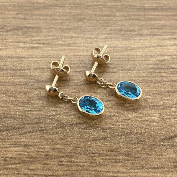 Gold blue topaz drop earrings.