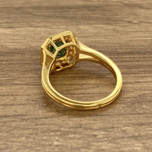 Gold ring with green gemstone.