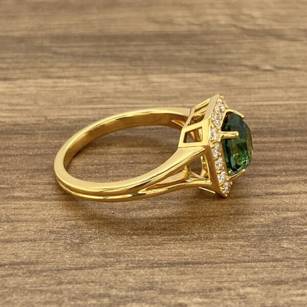 Gold ring with green tourmaline and diamonds.