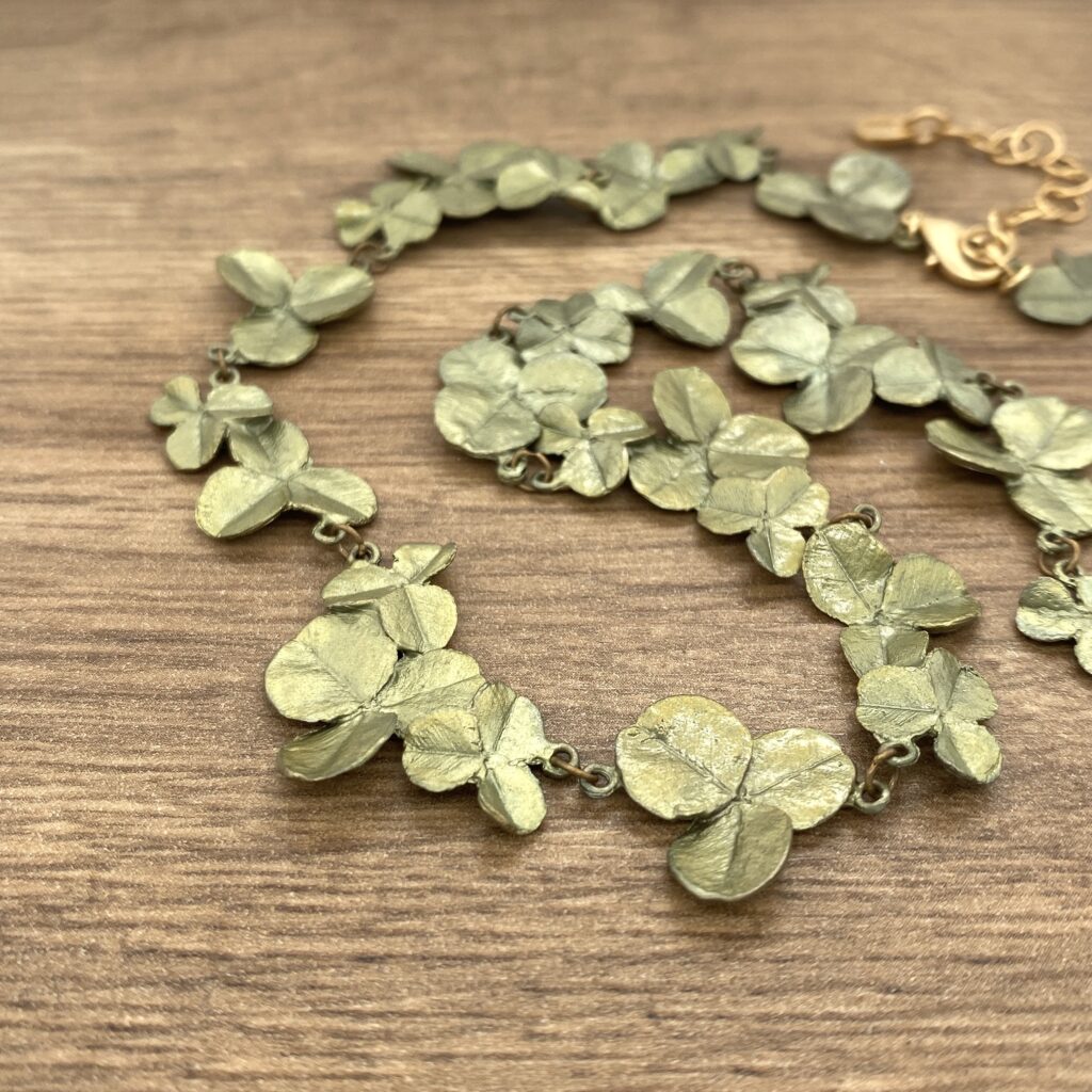 Olive green clover leaf necklace.