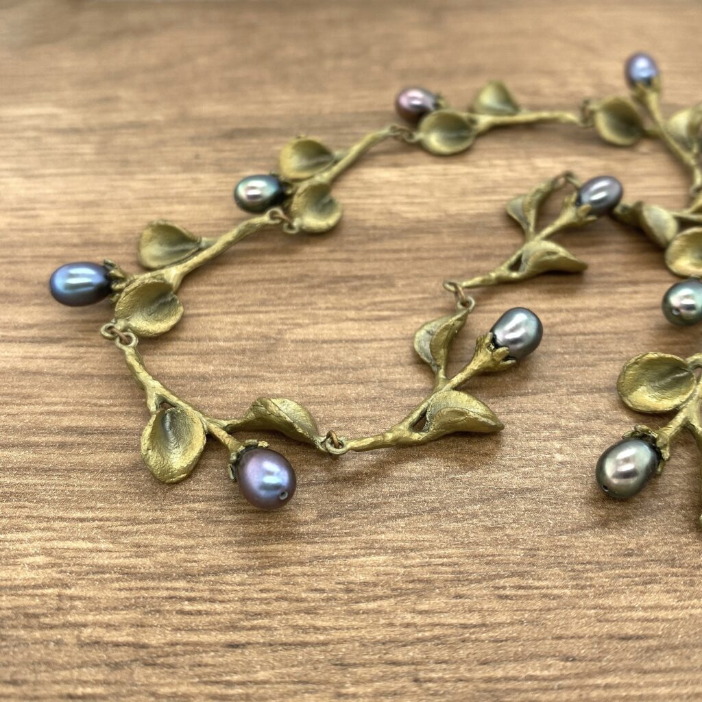 Bronze leaf necklace with pearls.
