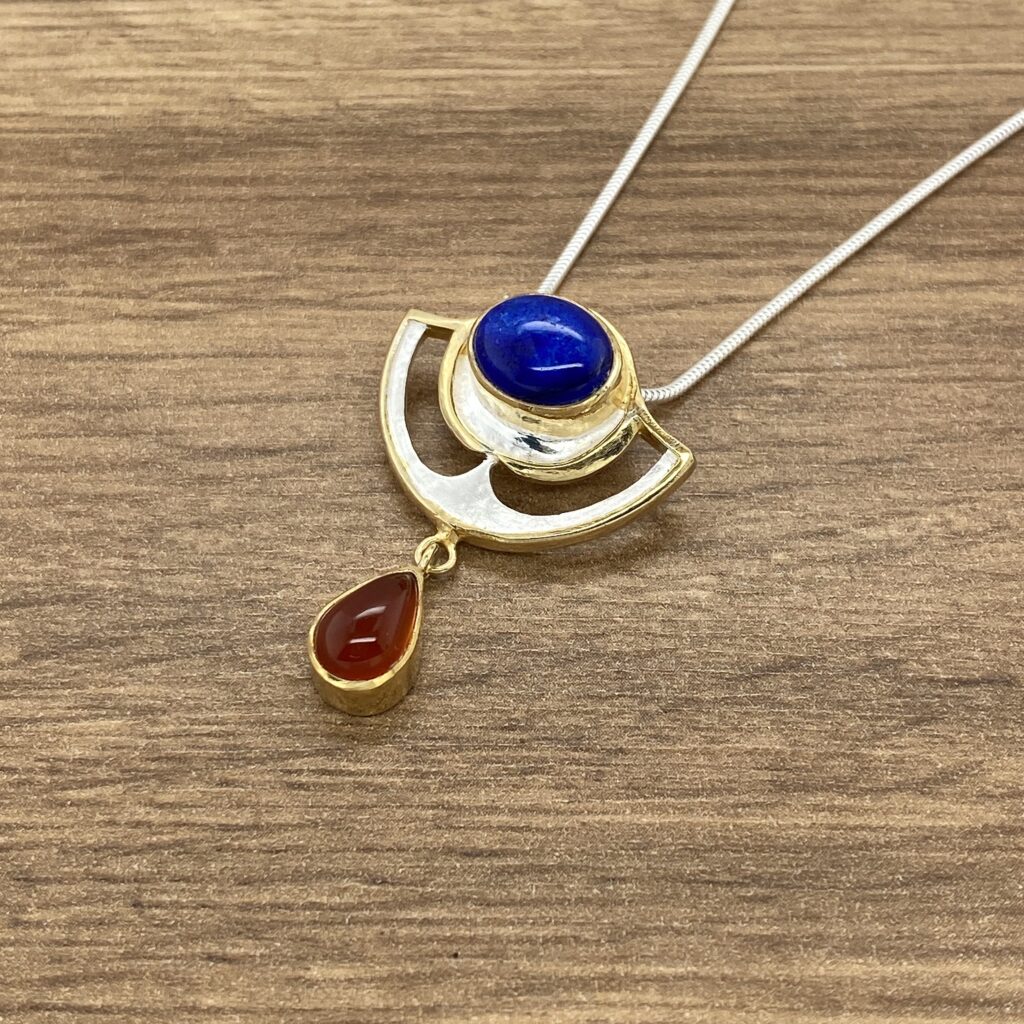 Gold necklace with blue and red stones.
