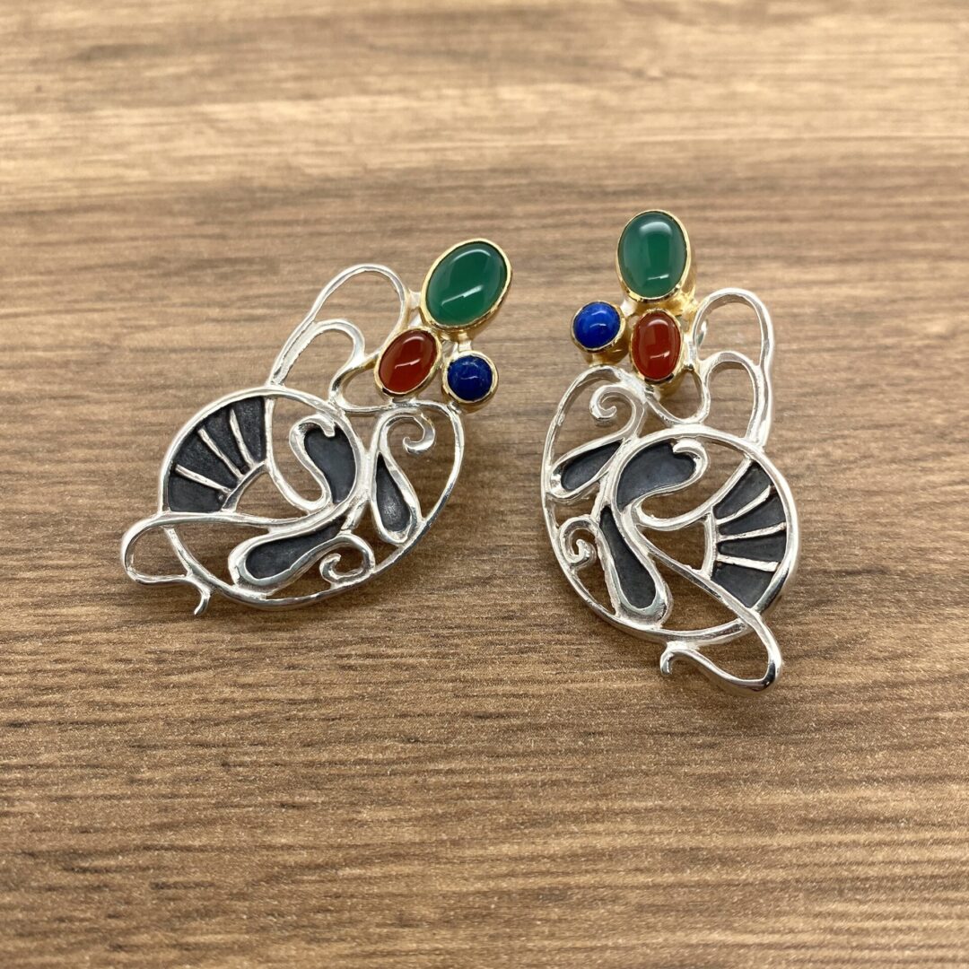 Silver earrings with colorful gemstone accents.