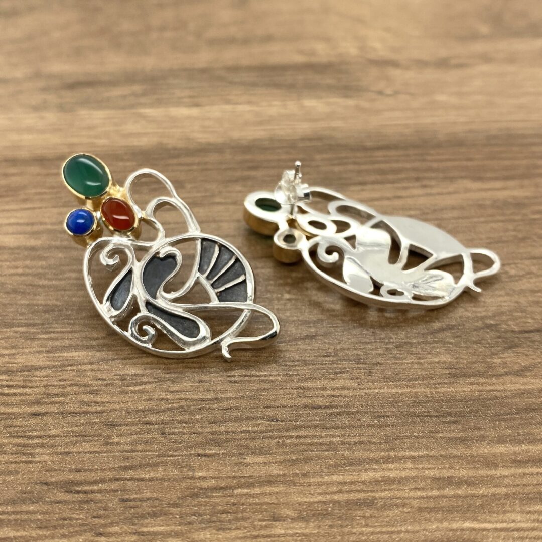 Silver earrings with colorful gemstone accents.