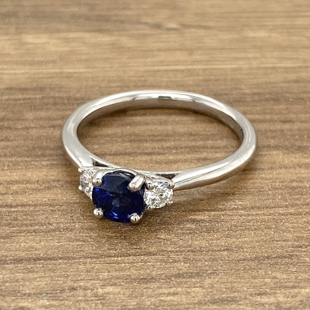 Silver ring with blue and clear gemstones.