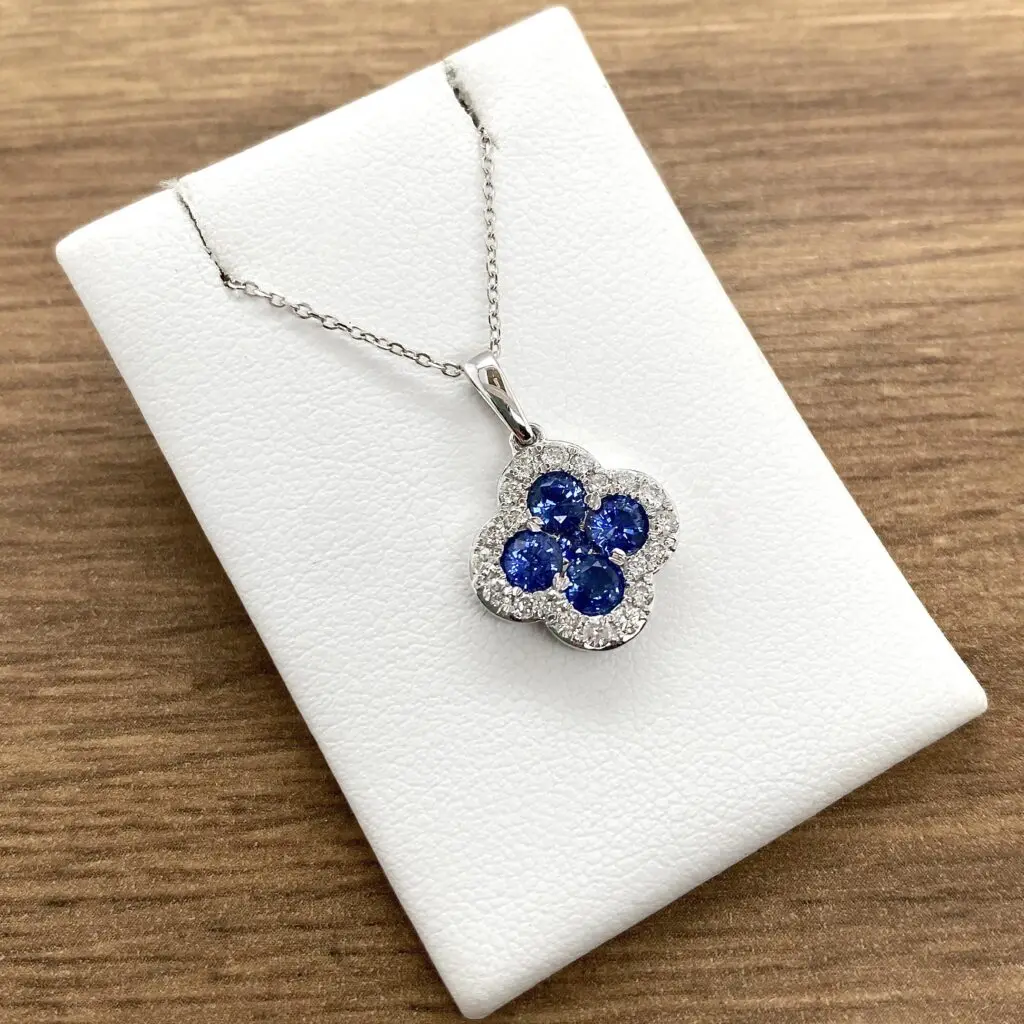 Blue gemstone pendant on silver necklace.